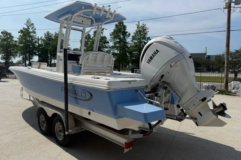 Slide: The Image of 2023 Robalo 246 Cayman boat with Yamaha engine on trailer, outdoors. - 4