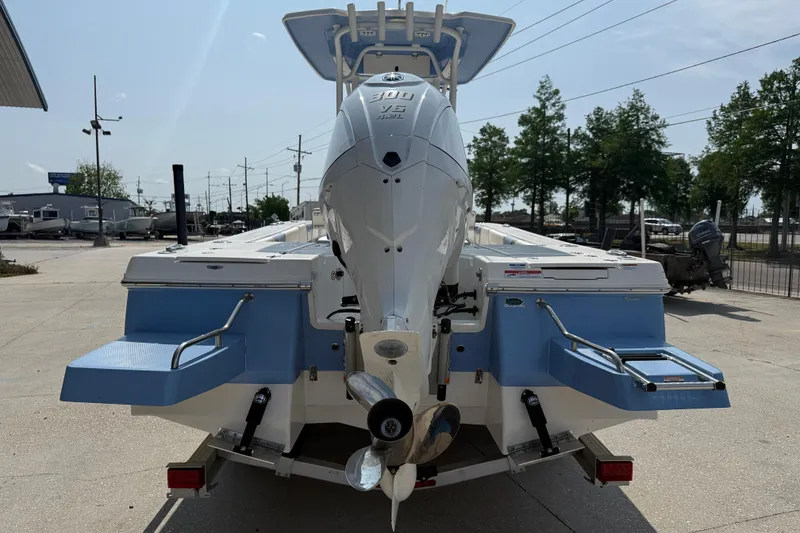 Slide: The Image of 2023 Robalo 246 Cayman boat with powerful outboard motor, parked outdoors. - 5