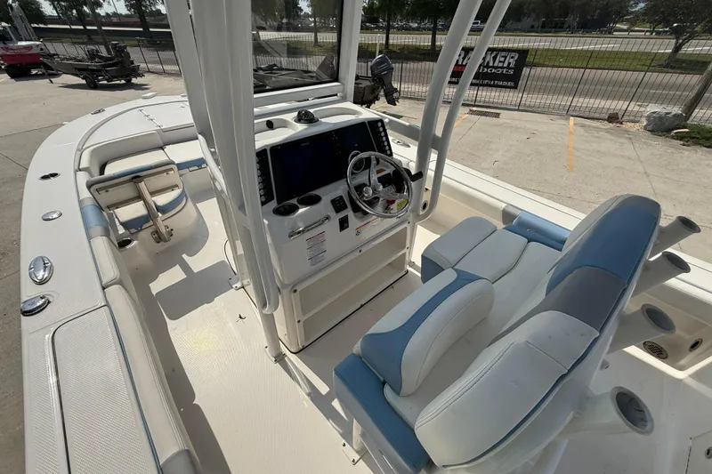 Slide: The Image of 2023 Robalo 246 Cayman boat interior with helm, seating, and controls. - 8