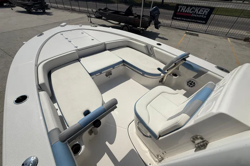 Slide: The Image of 2023 Robalo 246 Cayman boat interior with white and blue seating. - 9