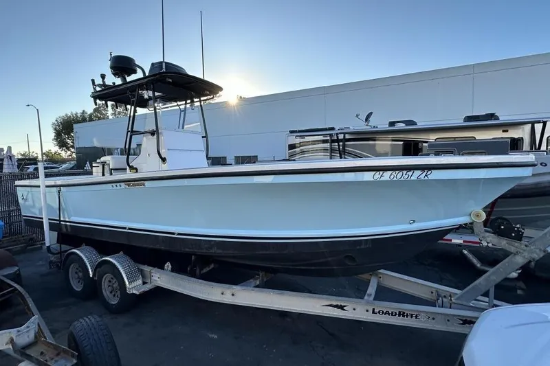 The Image of 2006 Albin 26 Center Console boat on trailer, parked outdoors in a lot. - 0