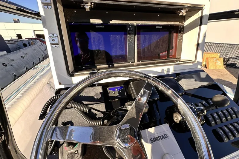 Slide: The Image of 2006 Albin 26 Center Console helm with Simrad navigation system and steering wheel. - 10