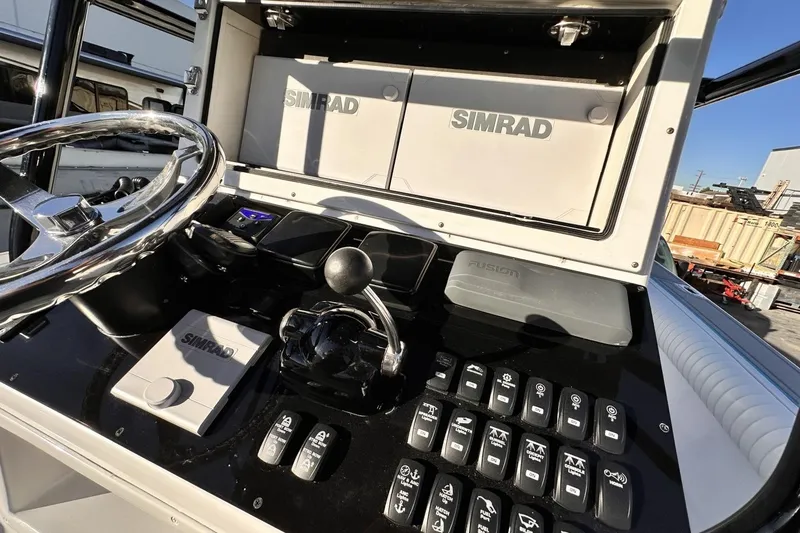 Slide: The Image of 2006 Albin 26 Center Console dashboard with Simrad navigation equipment and controls. - 11