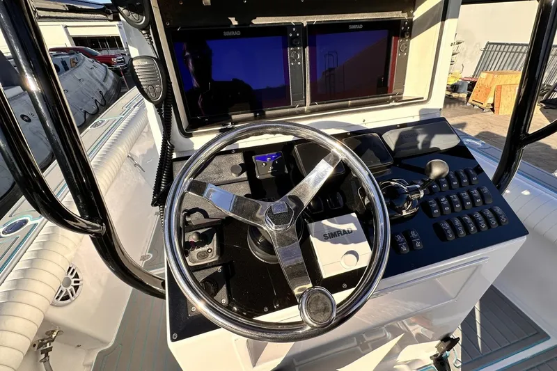 Slide: The Image of 2006 Albin 26 Center Console boat dashboard with steering wheel and navigation controls. - 12