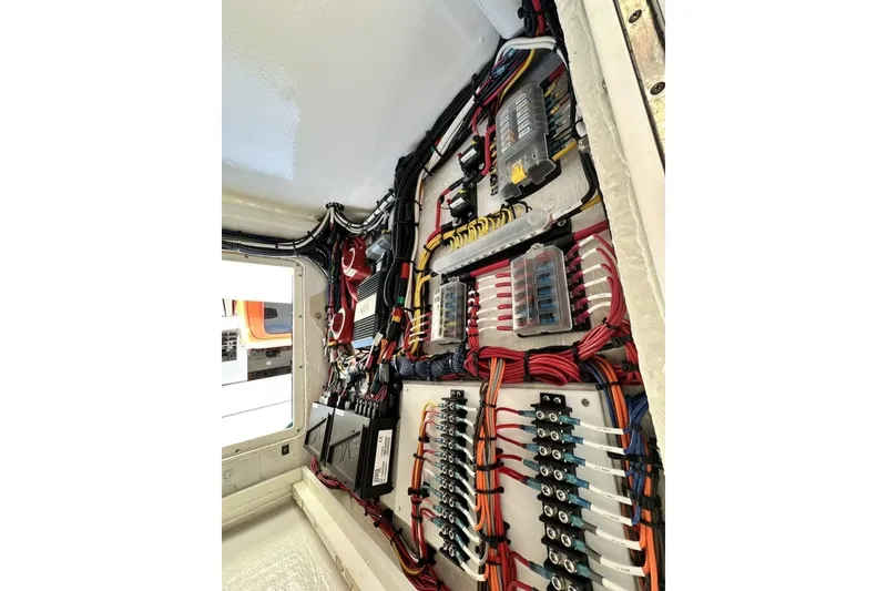 Slide: The Image of Electrical panel of a 2006 Albin 26 Center Console boat, showcasing organized wiring and components. - 13