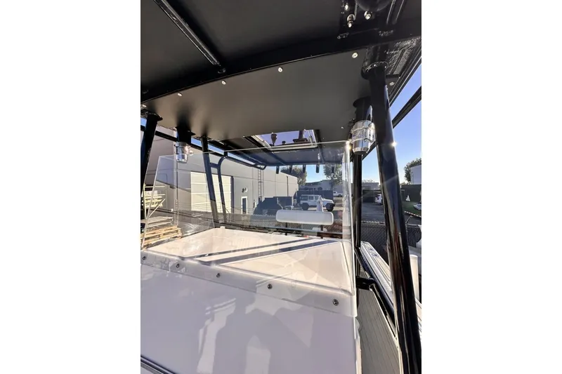 Slide: The Image of 2006 Albin 26 Center Console boat with sleek black canopy and clear windshield. - 15