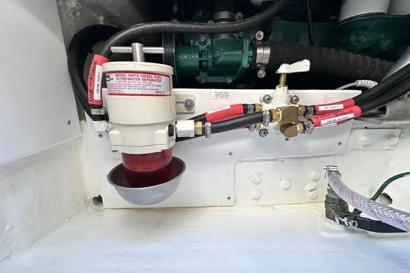 Slide: The Image of Engine compartment of a 2006 Albin 26 Center Console with fuel filter and hoses. - 16