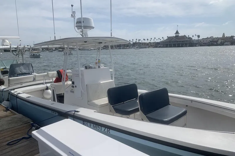 Slide: The Image of 2006 Albin 26 Center Console boat docked by the waterfront with scenic background. - 19
