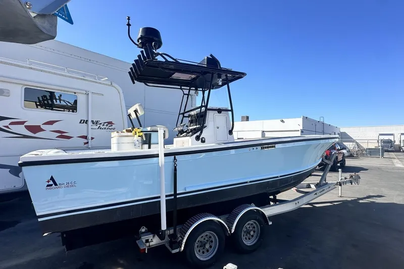 Slide: The Image of 2006 Albin 26 Center Console boat on trailer, parked outdoors under clear blue sky. - 3