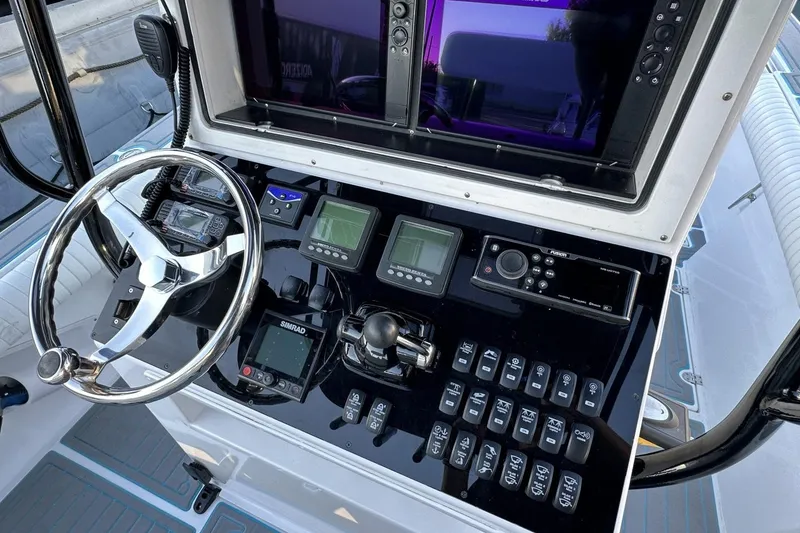 Slide: The Image of 2006 Albin 26 Center Console boat dashboard with steering wheel and electronic controls. - 5
