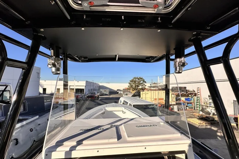 Slide: The Image of 2006 Albin 26 Center Console boat with Simrad navigation, docked in a marina. - 7