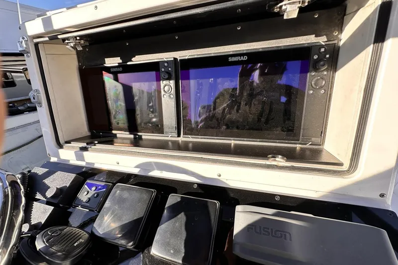 Slide: The Image of 2006 Albin 26 Center Console dashboard with Simrad navigation displays and controls. - 9