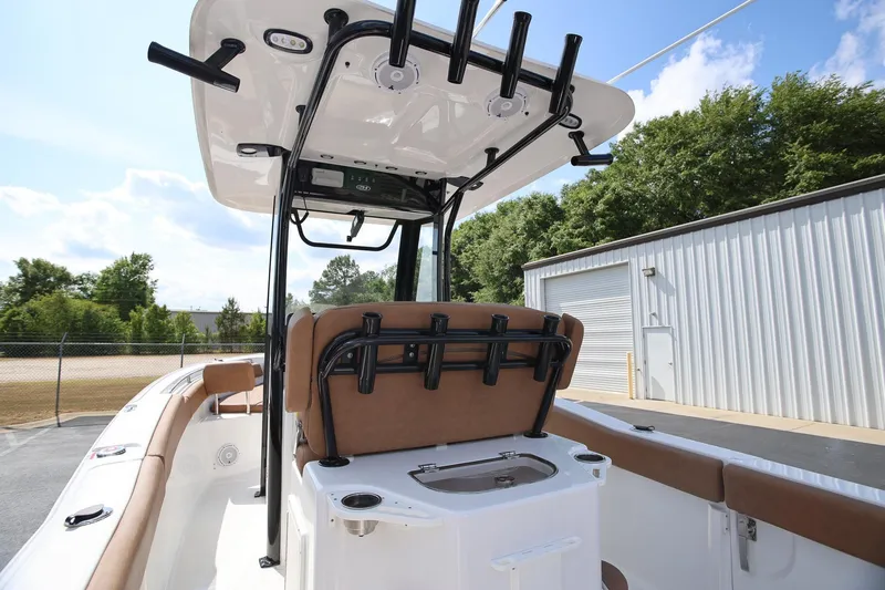 Slide: The Image of 2022 Sea Hunt Ultra 239 SE boat interior with seating and rod holders. - 10
