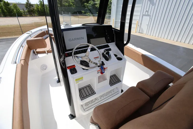 Slide: The Image of 2022 Sea Hunt Ultra 239 SE boat interior with Garmin navigation system and comfortable seating. - 12