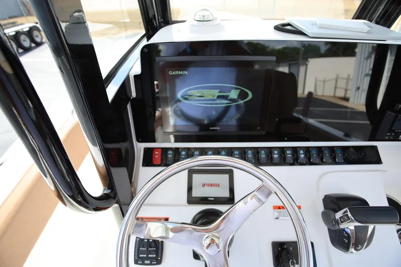 Slide: The Image of 2022 Sea Hunt Ultra 239 SE boat dashboard with Garmin display and Yamaha controls. - 14