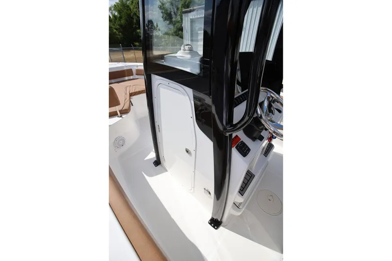 Slide: The Image of 2022 Sea Hunt Ultra 239 SE boat console with steering wheel and controls. - 17