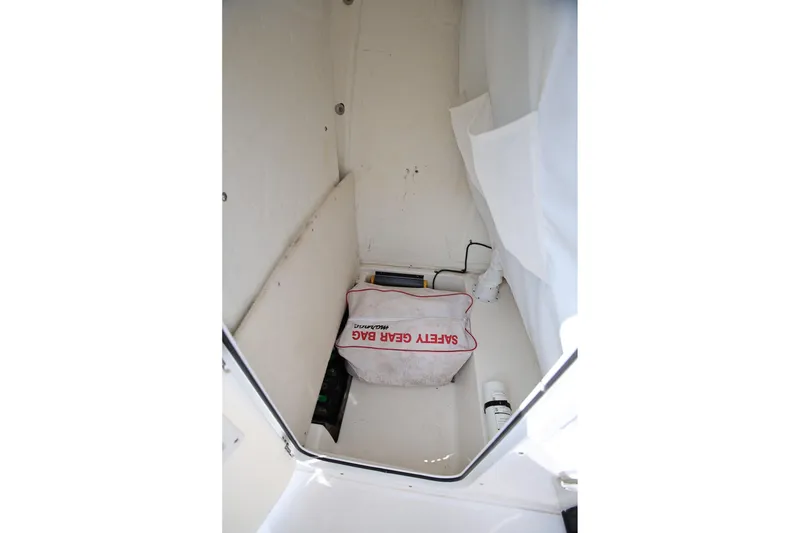 Slide: The Image of Interior storage compartment of 2022 Sea Hunt Ultra 239 SE with safety gear bag. - 19