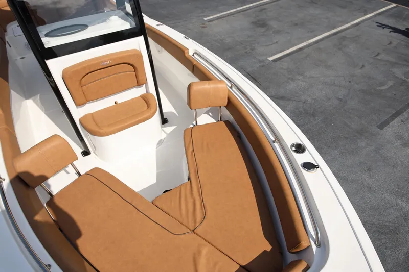 Slide: The Image of 2022 Sea Hunt Ultra 239 SE boat with tan seating and sleek design. - 20