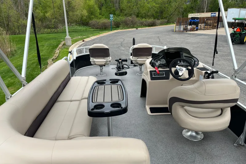 Slide: The Image of 2016 Sun Tracker Fishin' Barge 20 DLX interior with seating and steering console. - 4