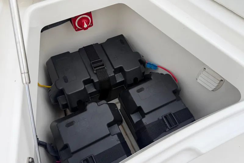 Slide: The Image of Battery compartment of 2019 Regulator 26XO boat with secured battery boxes. - 12