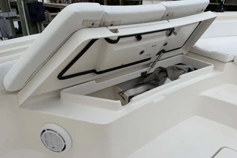 Slide: The Image of Open storage compartment on a 2019 Regulator 26XO boat, showcasing interior space and design. - 13