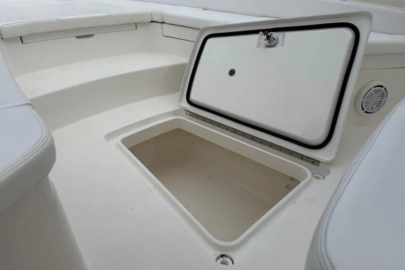 Slide: The Image of 2019 Regulator 26XO boat storage compartment with open hatch, showcasing interior space. - 14