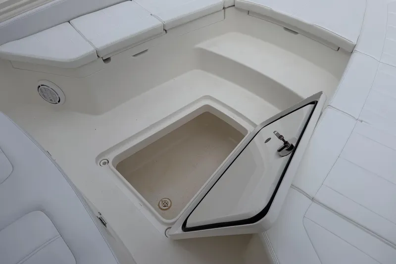 Slide: The Image of 2019 Regulator 26XO boat storage compartment with open hatch, showcasing spacious interior. - 15