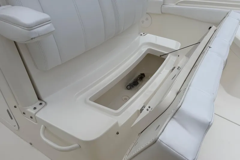 Slide: The Image of 2019 Regulator 26XO boat seat with open storage compartment. - 18