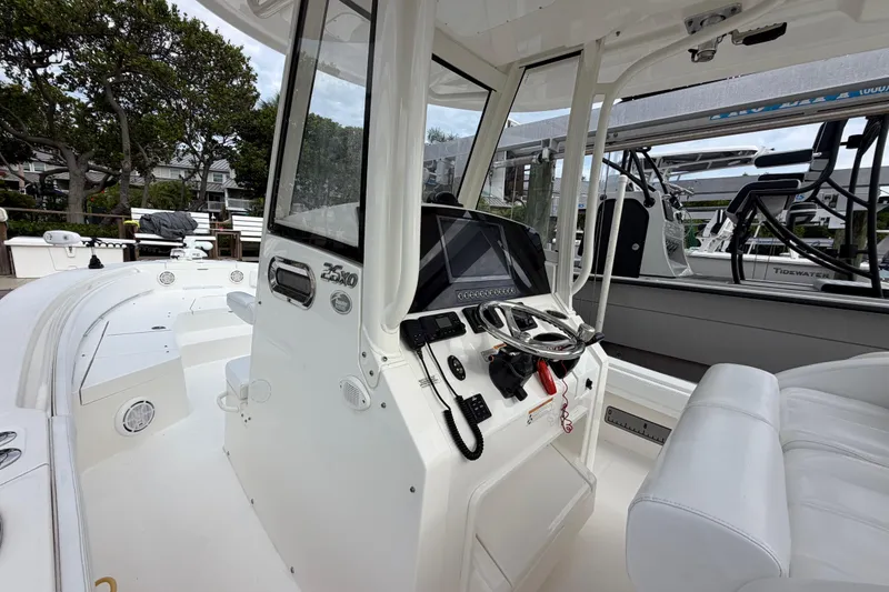 Slide: The Image of 2019 Regulator 26XO boat cockpit with steering wheel and navigation equipment. - 25