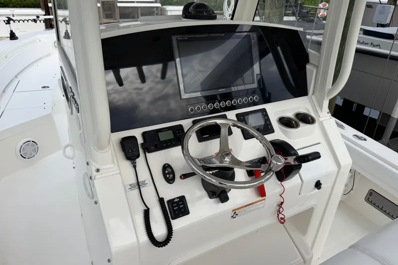 Slide: The Image of 2019 Regulator 26XO boat console with steering wheel and navigation equipment. - 28
