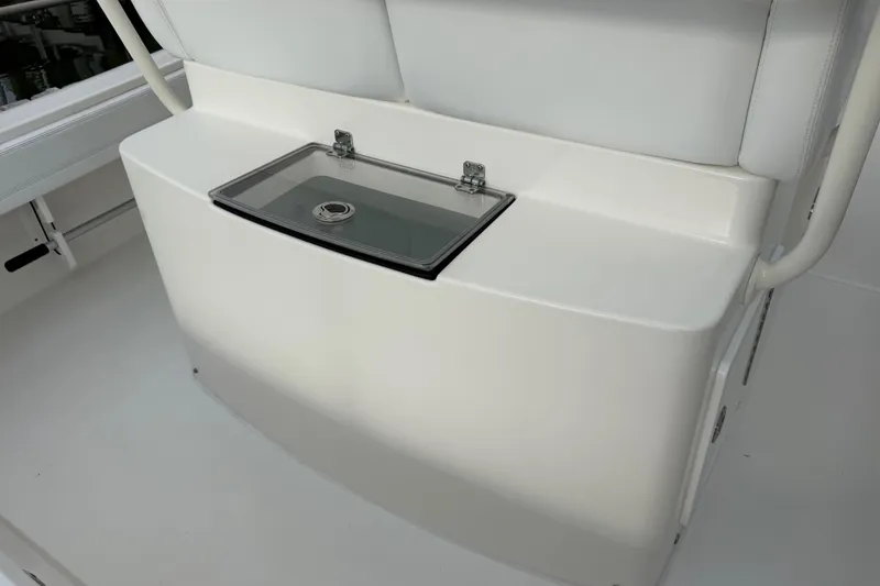 Slide: The Image of 2019 Regulator 26XO boat seating with storage compartment and cushioned backrest. - 33