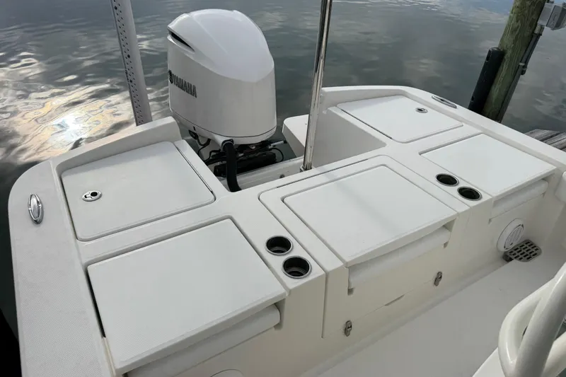 Slide: The Image of 2019 Regulator 26XO boat with Yamaha outboard engine, docked by calm water. - 35
