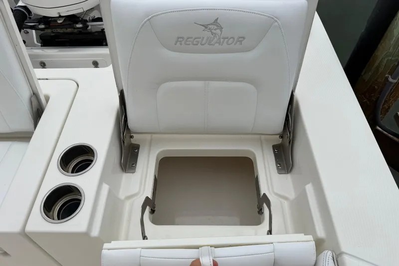 Slide: The Image of 2019 Regulator 26XO boat seat with storage compartment and cup holders. - 39