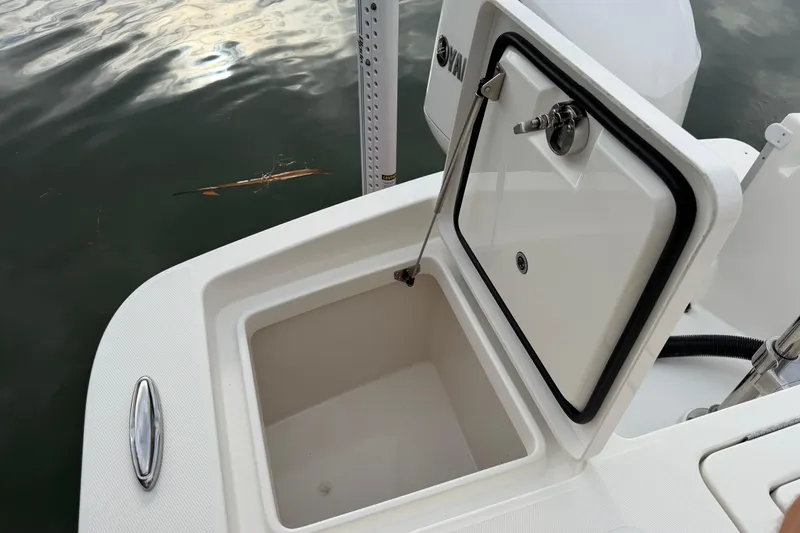 Slide: The Image of Open storage compartment on a 2019 Regulator 26XO boat, near water surface. - 41