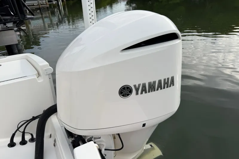 Slide: The Image of Yamaha outboard motor on 2019 Regulator 26XO boat, docked by calm water. - 43