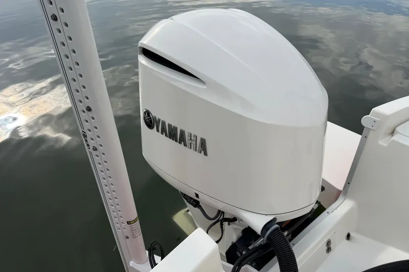 Slide: The Image of 2019 Regulator 26XO boat with Yamaha outboard motor on calm water. - 44