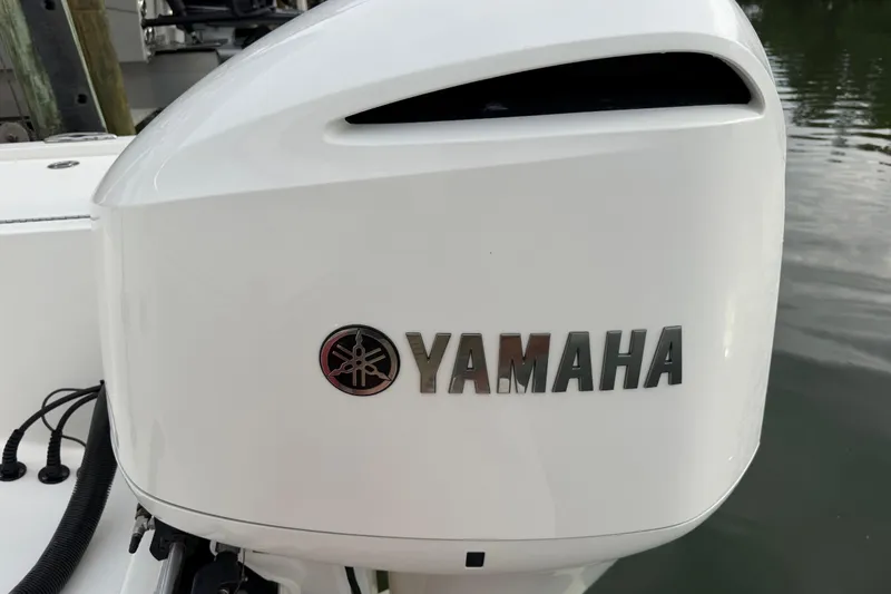 Slide: The Image of Yamaha outboard motor on 2019 Regulator 26XO boat, docked by water. - 46