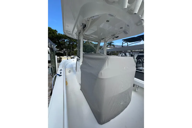 Slide: The Image of 2019 Regulator 26XO boat with covered console, docked under clear blue sky. - 47