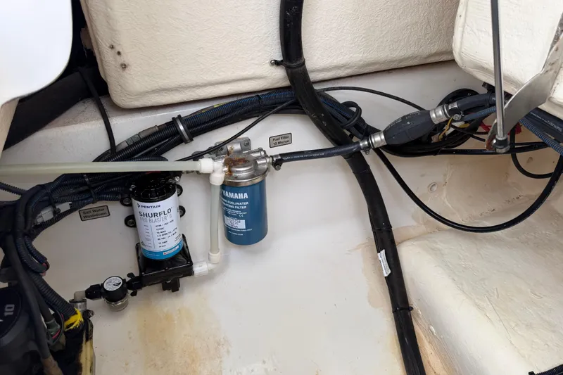 Slide: The Image of 2019 Regulator 26XO boat interior showing water pump and filter system. - 52