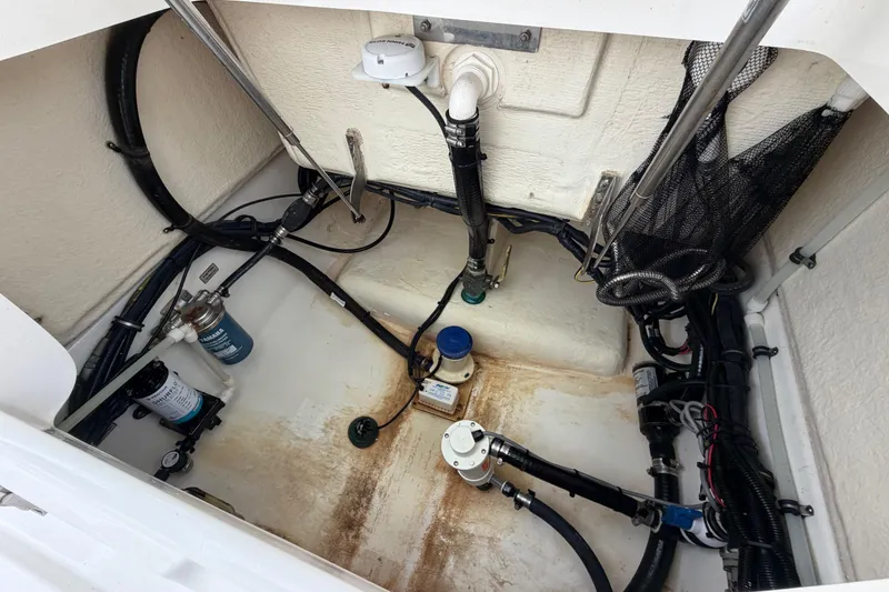 Slide: The Image of 2019 Regulator 26XO boat bilge area with pumps and wiring. - 54