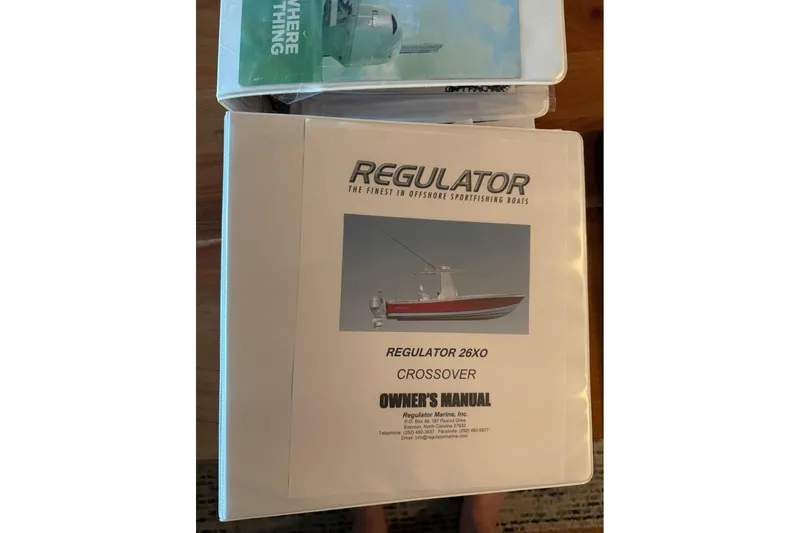 Slide: The Image of Owner's manual for 2019 Regulator 26XO Crossover boat, featuring cover image and branding. - 58