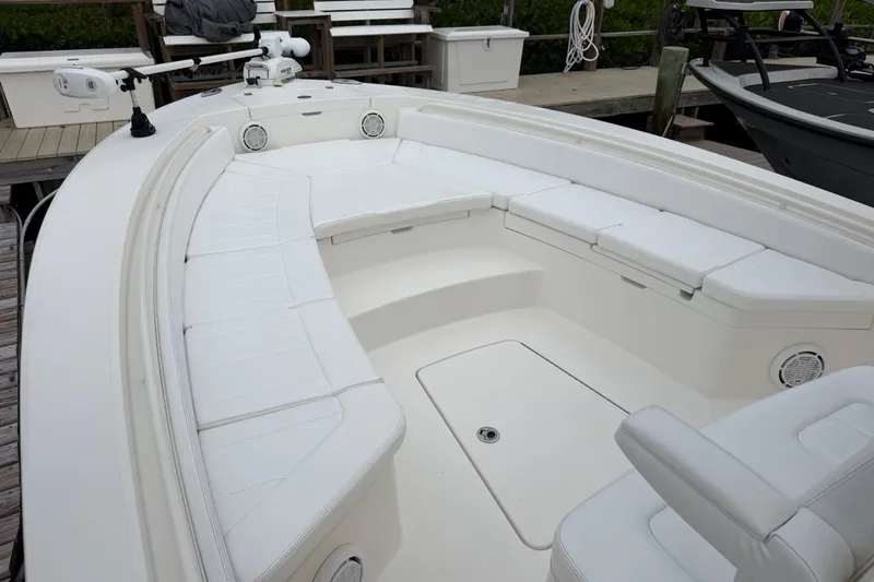 Slide: The Image of 2019 Regulator 26XO boat with spacious white seating and modern design at dock. - 7