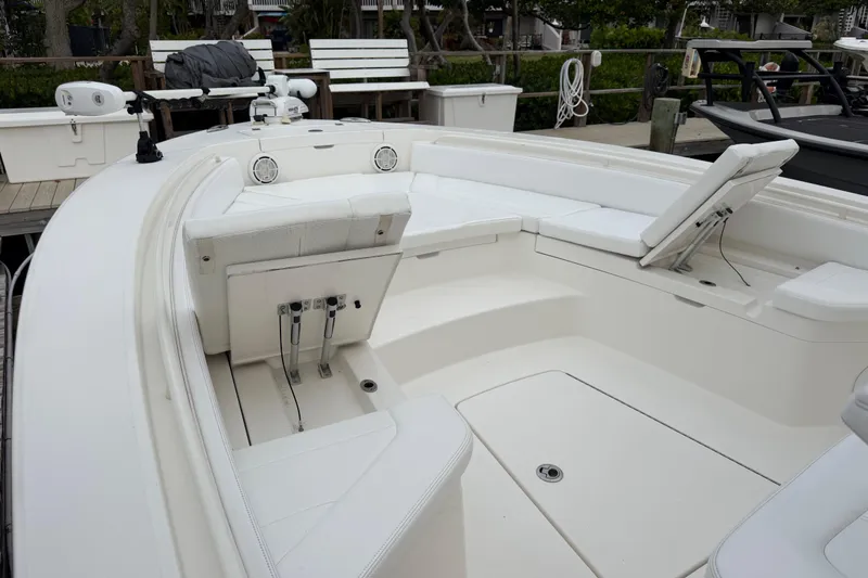 Slide: The Image of 2019 Regulator 26XO boat interior with white seating and deck, docked at marina. - 8