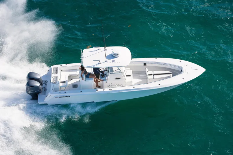 Slide: The Image of 2026 Contender 32 ST boat cruising on clear blue water. - 3