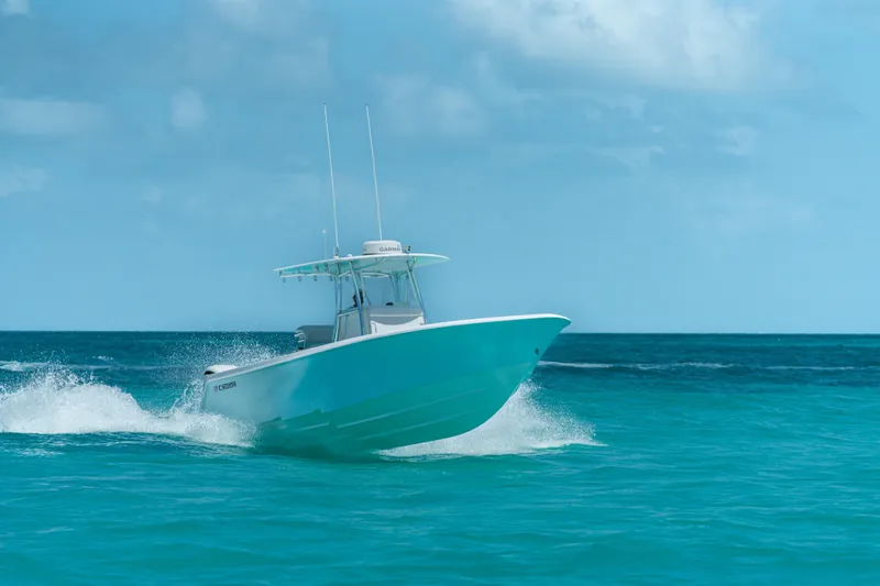 Slide: The Image of 2026 Contender 32 ST boat cruising on clear blue ocean waters. - 4