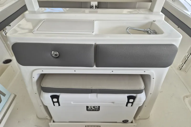 Slide: The Image of 2026 Key West 260 Center Console boat interior with sink and storage area. - 10