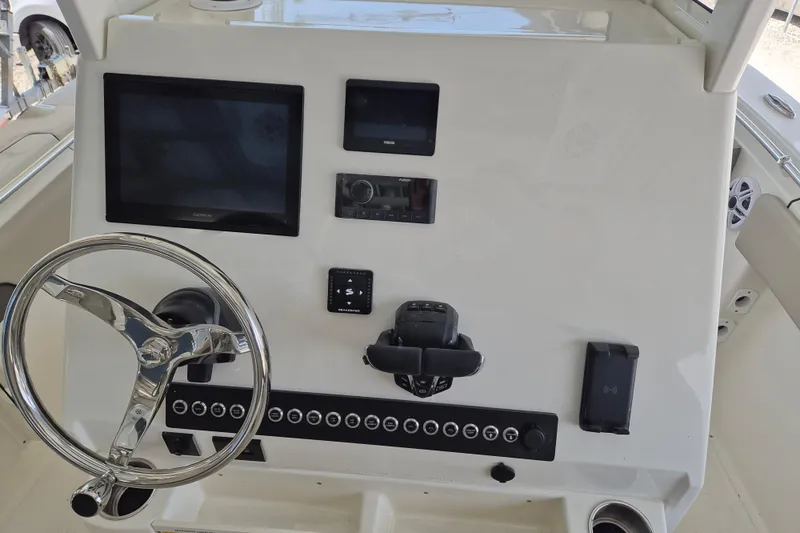 Slide: The Image of 2026 Key West 260 Center Console dashboard with steering wheel and electronic displays. - 14