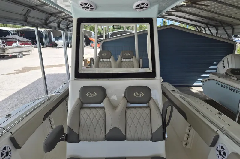 Slide: The Image of 2026 Key West 260 Center Console boat interior with cushioned seating and modern design. - 20