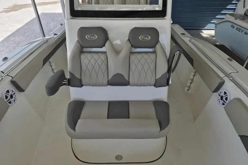 Slide: The Image of 2026 Key West 260 Center Console boat interior with cushioned seating and modern design. - 21