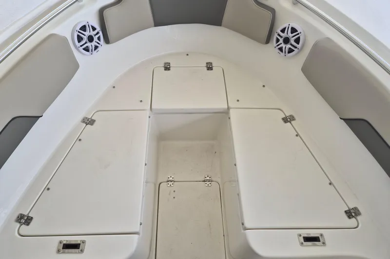 Slide: The Image of 2026 Key West 260 Center Console boat interior with storage compartments and speakers. - 22